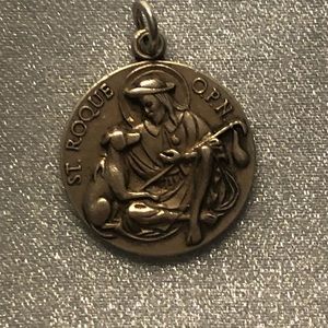 Gorgeous vintage charm.  Has a loop and silver.   St. Roque with a dog.